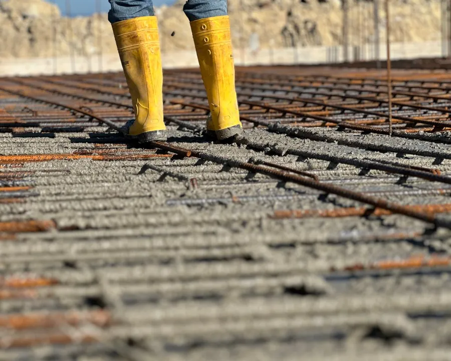 A close view of reinforcing bar laid across compacted ground before a concrete pour