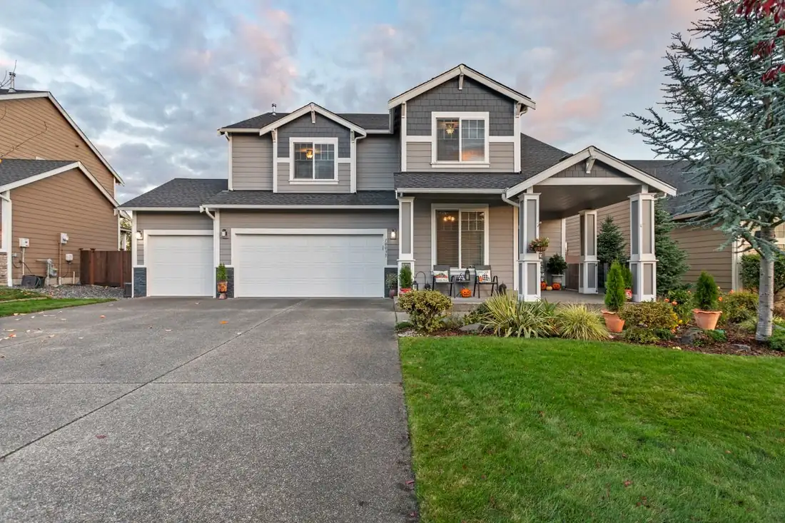 A finished residential concrete driveway and front walk at a two-car garage