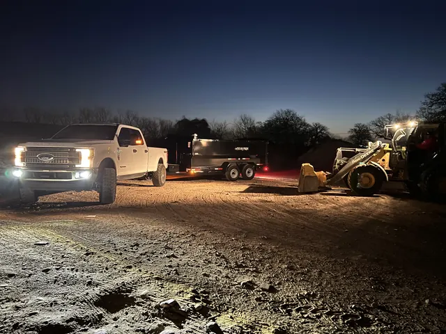 The work truck and loader on a job before dawn