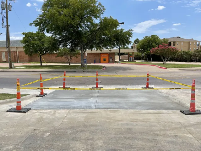 A replaced concrete section in a commercial parking lot