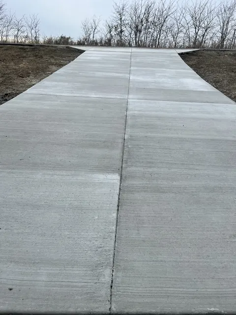 A wide concrete driveway with a flared apron at the road