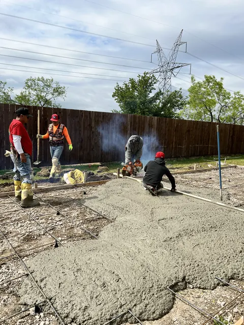 The crew placing and finishing fresh concrete