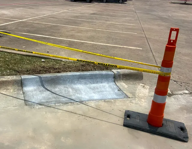 A commercial concrete patch taped off while it cures