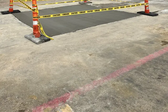 A new section of commercial parking lot taped off with cones